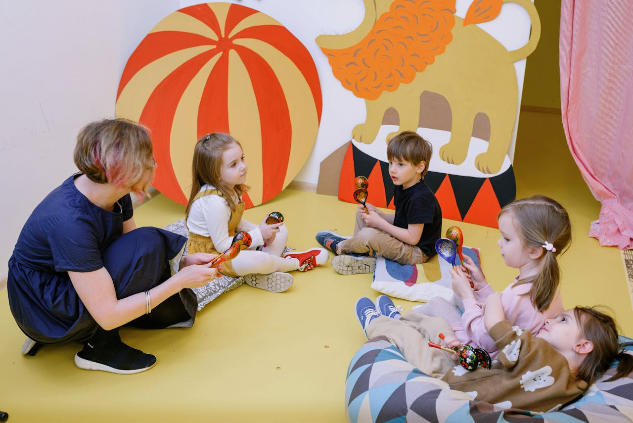 Kids playing with maracas in a colorful playroom with a teacher.