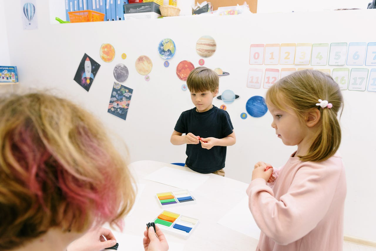 Children playing with modeling clay in a classroom, fostering creativity and education.